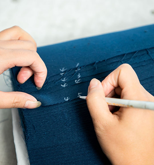 A worker is marking the cutting pieces