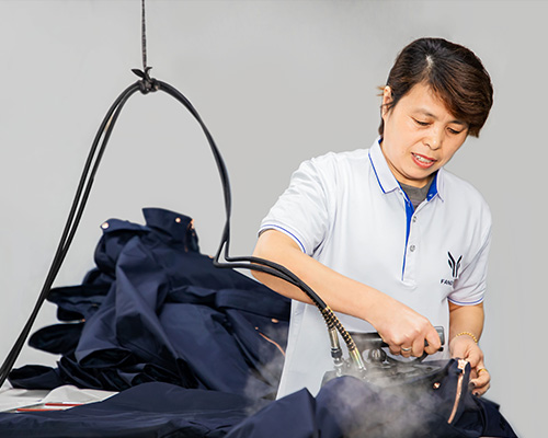 A woman is ironing the finished jackets