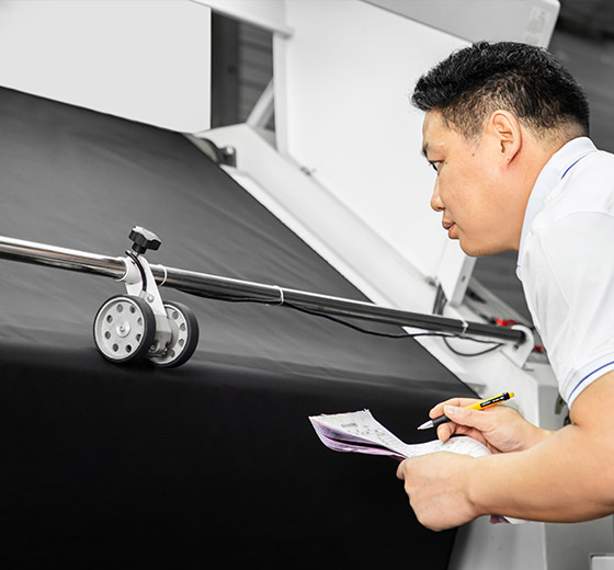 A man is inspecting the fabrics