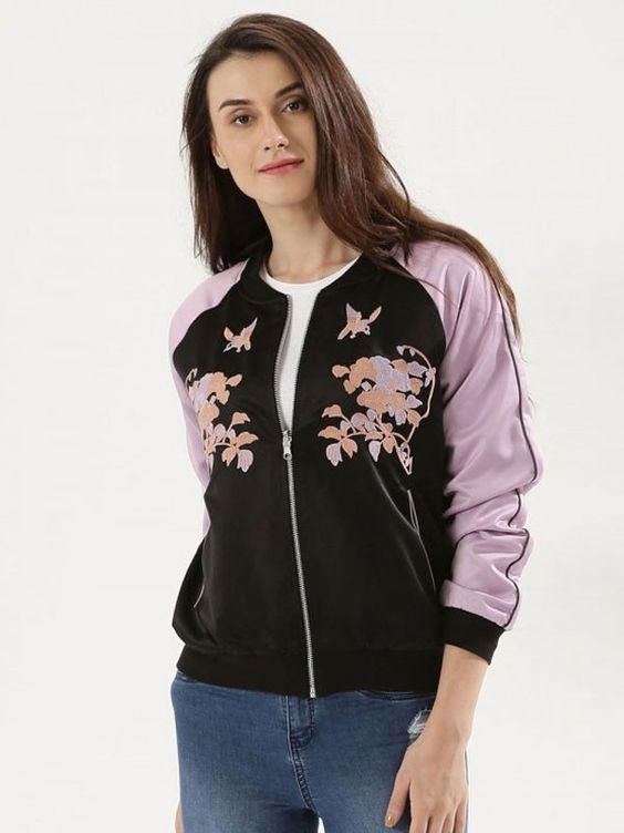 woman wearing black and pink bomber jacket with embroidery