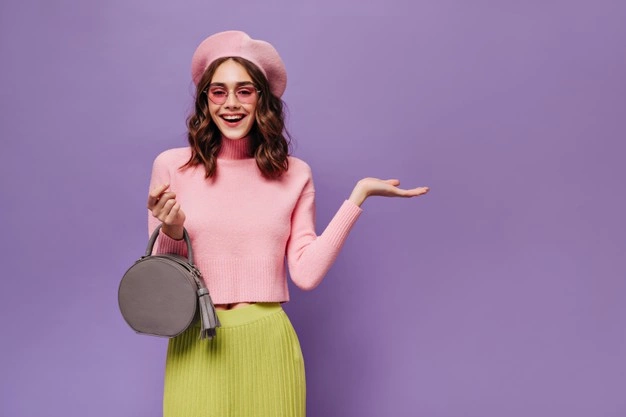 girl wearing pink sweater, pink shades, and pink beret matched with yellow skirt and grey handbag