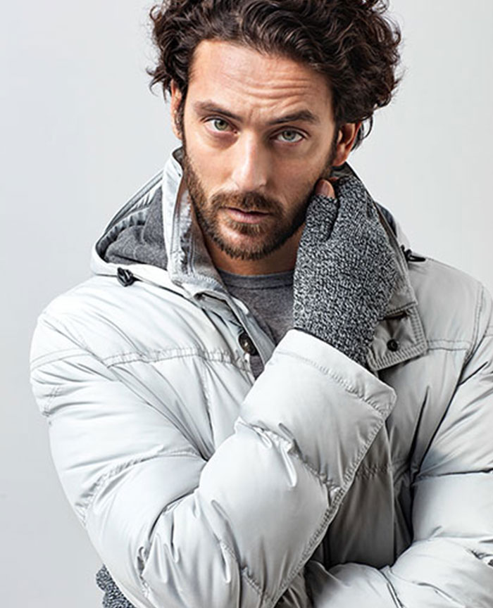 man wearing a white quilted bomber jacket